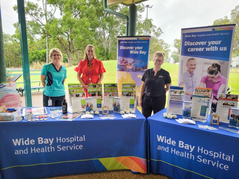 Wide Bay Hospital and Health Service staff standing at a Uni Life Market Day stall at CQUniversity.