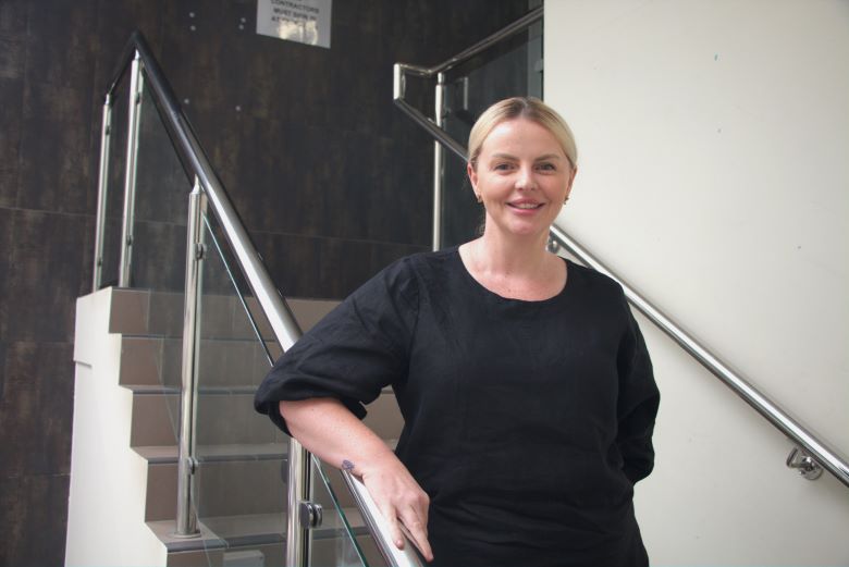 Hospital employee standing on steps of building
