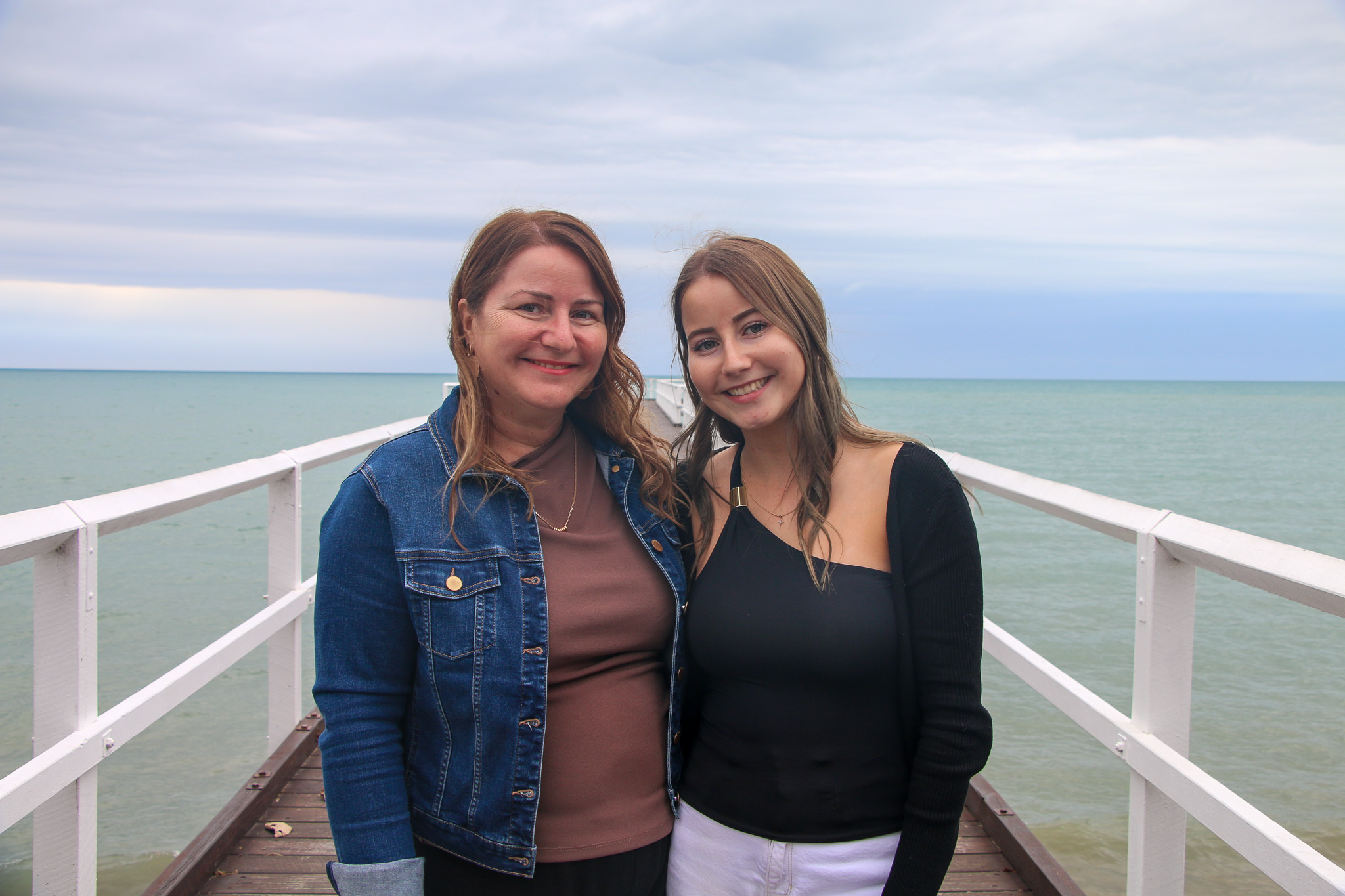 Mother and daughter walking along a pier at Hervey Bay