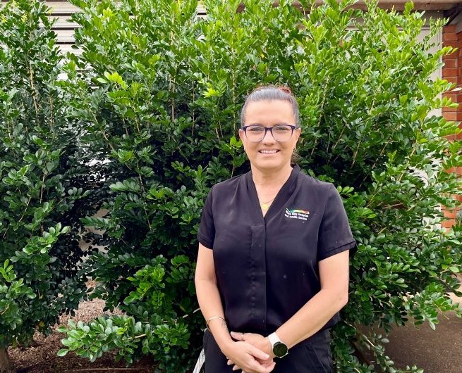 Wide Bay Hospital and Health Service employee standing outside in garden