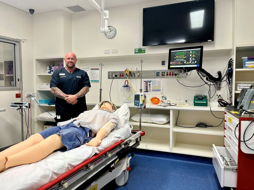 Male nurse standing in treatment room