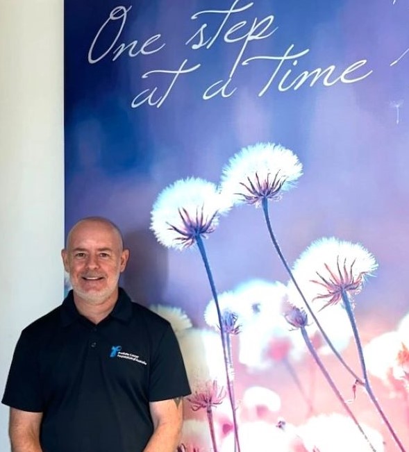 Male nurse standing in foyer of Cancer Care Unit